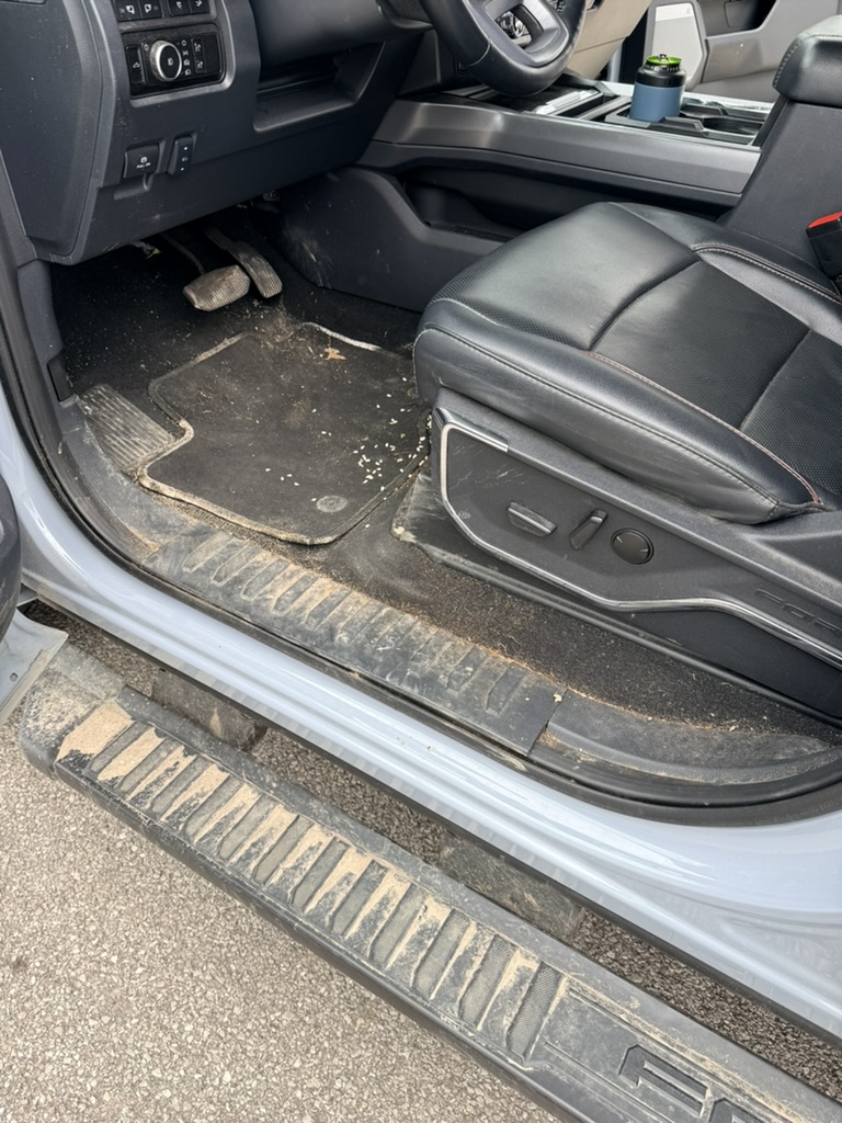 Dirty floor mats and door sill before detailing in North Olmsted Ohio